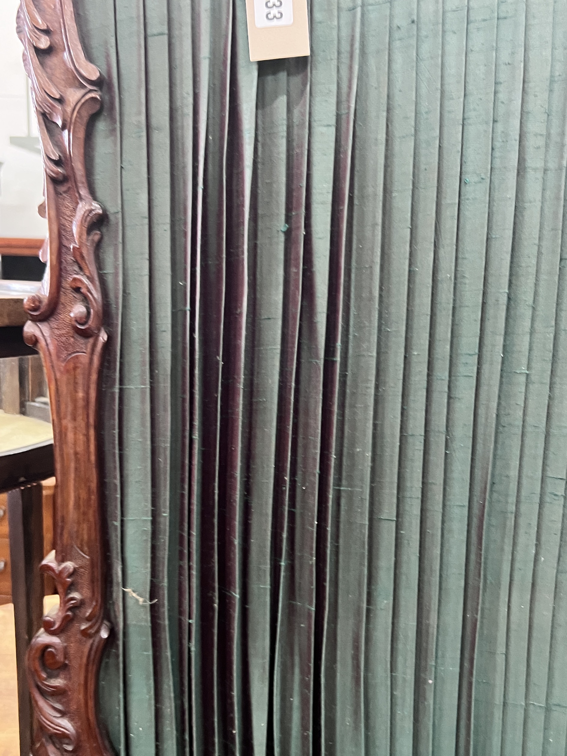 A small Victorian style mahogany two fold carved screen, each panel width 50cm, height 112cm